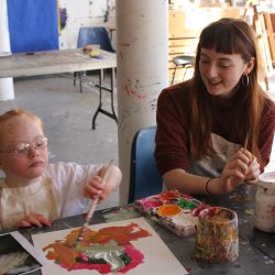 Volunteer Corah Ambrose with young artist