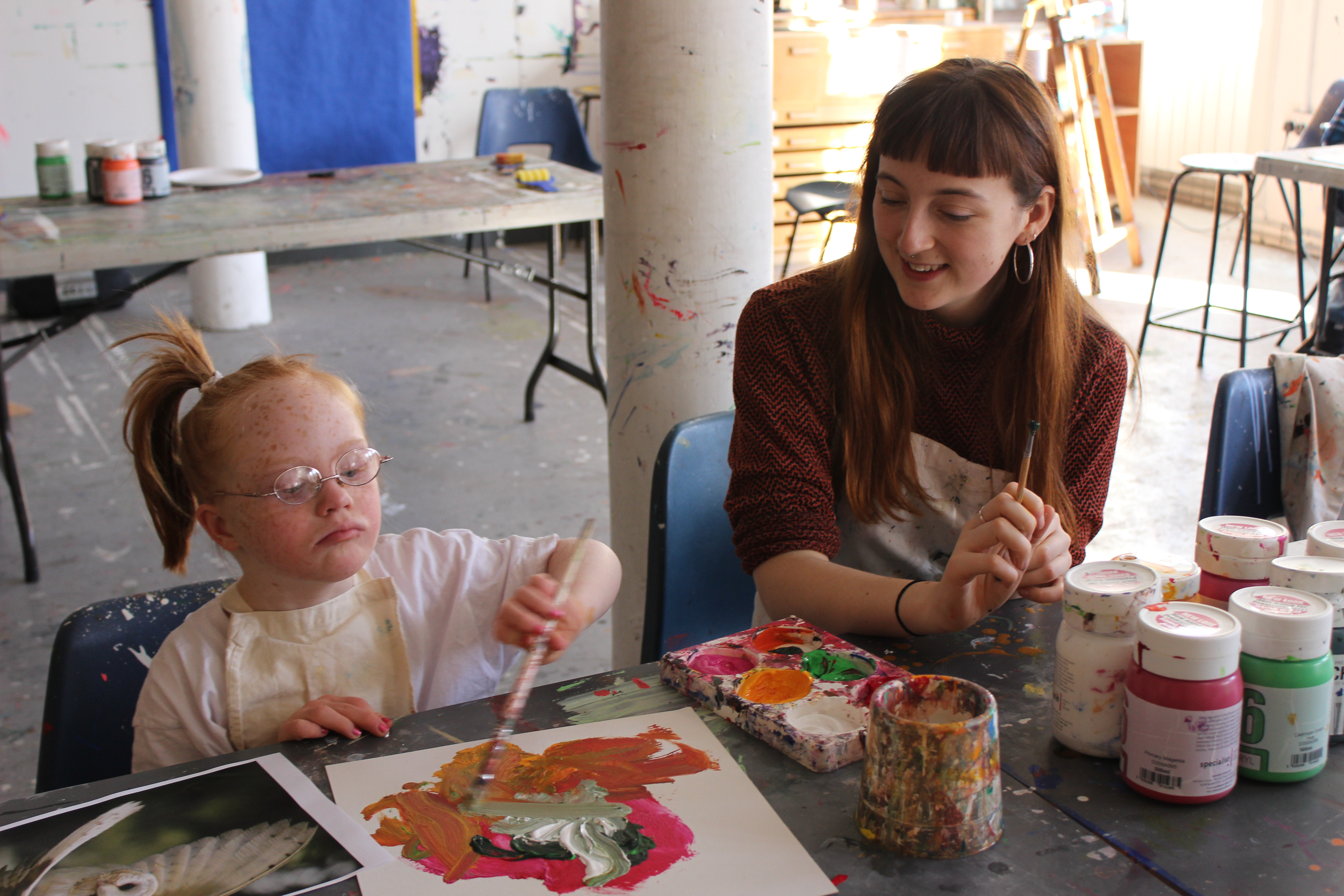 Volunteer Corah Ambrose with young artist