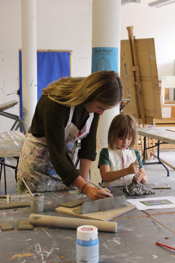 Volunteer Elisa Coffey with young artist