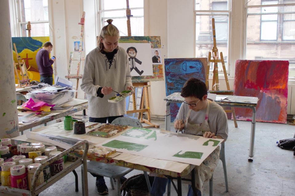 volunteer helping artist at project ability