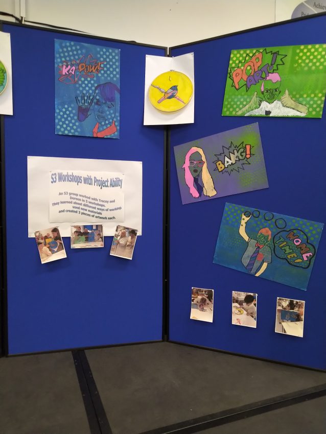 art work hanging on blue boards at Abercorn School. 