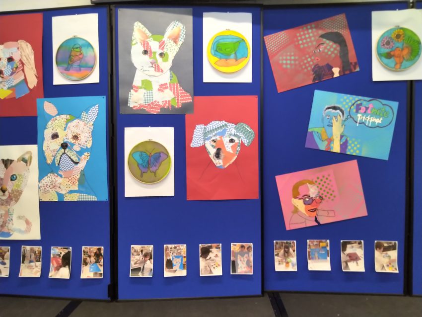 art work hanging on blue boards at Abercorn School. 