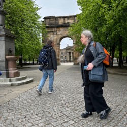 two people walking near the entrance at Glasgow Green
