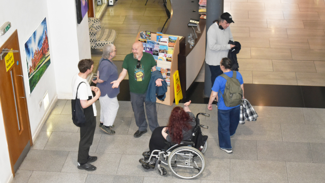 People chat and gather at the exhibition opening at Trongate 103