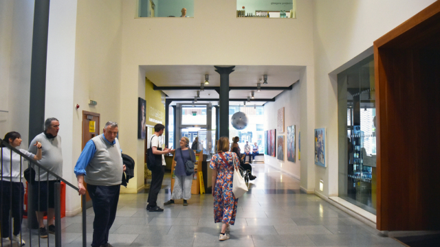 People mill about in the foyer of Trongate 103 in the area of the exhibition