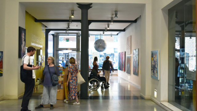 People mill about in the foyer of Trongate 103 in the area of the exhibition