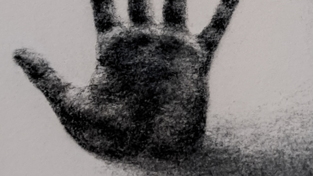 A shadowy painting of a hand in black ink.