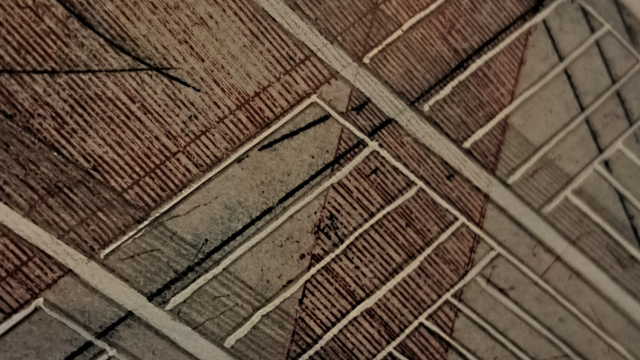 A geometrical dark red, black and white print, of parallel and perpendicular lines.