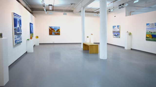 Exhibition view showing paintings on the wall and ceramic and textile pieces on plinths around the gallery space.